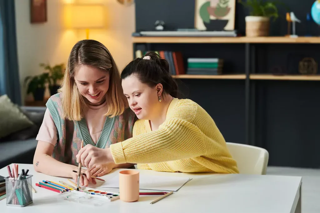 A disabled woman and her teacher doing art