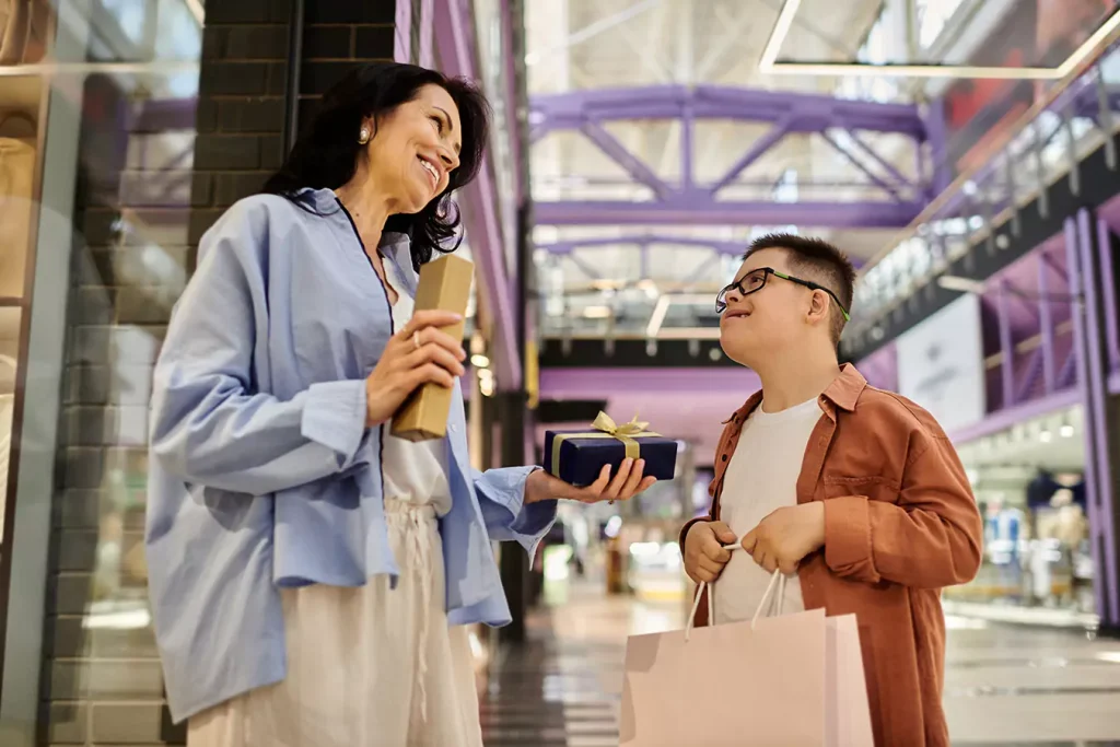 A disabled boy and his mum shopping for gifts